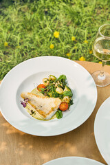 Zander fillet with vegetable garnish and beurre blanc, bright natural light, overhead composition