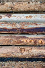 Detailed macro shot of rusty metal pipes showing layers of corrosion, oxidation patterns, and industrial decay over time.

