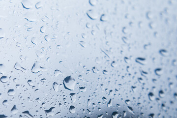 Close up of raindrops falling on glass windows
