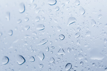 Close up of raindrops falling on glass windows
