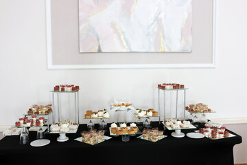 Cakes, cupcakes and pastries on a candy bar. Sweet table.