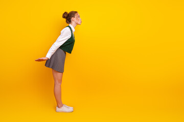 Young student posing playfully against a vibrant yellow background, expressing charm and style, showcasing a fun mood