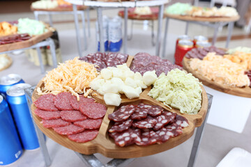 Salty smoked ham, salami and cheese on a buffet table.