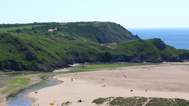 Three Cliffs Bay beach in South Wales, panning right.