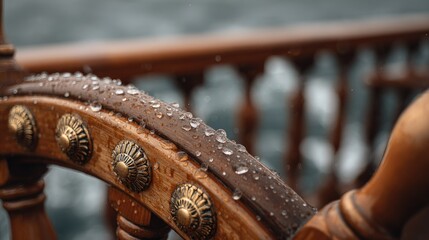 Closeup of a weathered wooden ship's wheel with rain drops