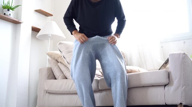 an elderly woman with bladder control problems accidentally peeing in her pants while rushing to the toilet, showing signs of stress urinary incontinence