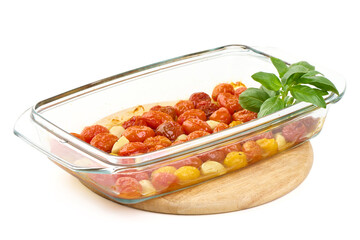 Roasted Tomatoes with Basil in Baking Dish, isolated on white background.