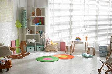 Stylish playroom with toys and furniture. Interior design