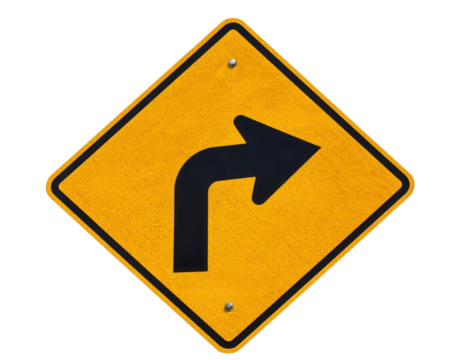 A yellow diamond-shaped traffic sign with a bold black right turn arrow indicating a sharp right curve ahead.