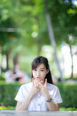A beautiful and lovely female student wearing the uniform of her university faculty, posing...