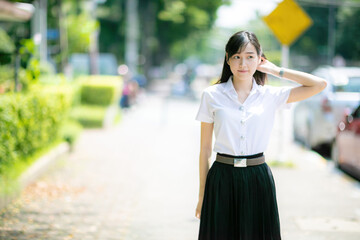 The university media department featured a cute college student with an Asian look posing for...