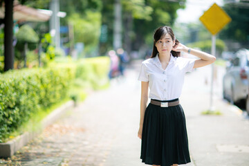 With her cute smile and Asian look, the college student spent the day posing for photos on various...