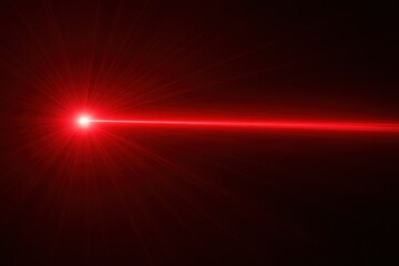 Bright red laser beam shining through darkness