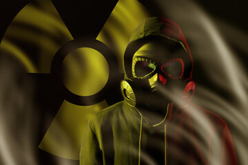 Man wearing gas mask in smoke against black background. Radioactive sign behind him