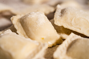 Fresh homemade uncooked ravioli pasta sprinkled with flour