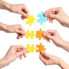 Hands assembling puzzle pieces illustrating teamwork
