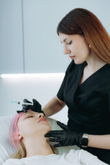  an aesthetic professional performing an injection procedure. Beauty treatment