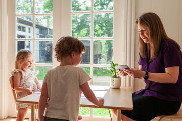 allied health professional speech therapist using speech development sound cards with young child