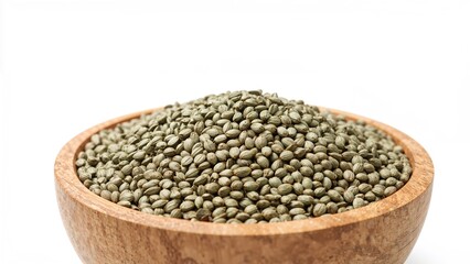 Obraz premium Detailed view of hemp seeds stacked in a wooden dish against a white background