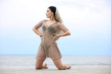 Woman Posing Gracefully on a Beach Boardwalk