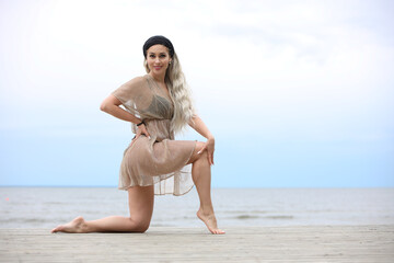 Woman Posing Gracefully on a Beach Boardwalk