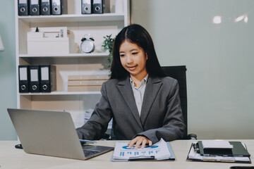 Portrait of Young Asian woman hand freelancer is working her job on computer tablet in modern...