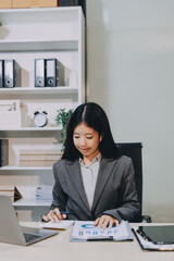 Portrait of Young Asian woman hand freelancer is working her job on computer tablet in modern...