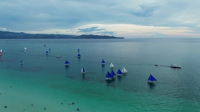 Afternoon Drone Footage of Paraw Sailboats on Calm Blue Waters
