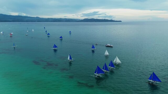 Drone Shot of Paraw Sailboats on Blue Ocean in the Afternoon