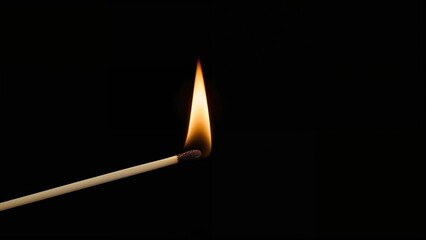 Lighting a match with a dark backdrop