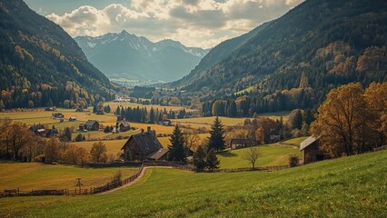 Obraz premium Beautiful autumnal landscape featuring a mountain valley, forests, agricultural fields, and rustic homes.
