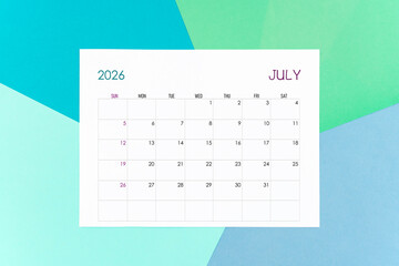 July calendar card for 2026 year on colorful background. Flat lay.