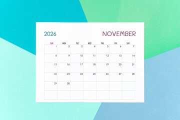 November calendar card for 2026 year on colorful background. Flat lay.