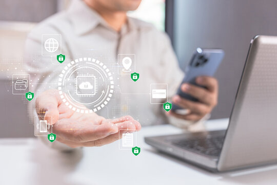 Person using smartphone and laptop with digital cybersecurity icons representing data protection and secure networking.