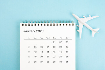 January 2026 calendar and airplane toy on blue color background, Travel plan concepts.