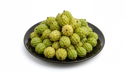 Fototapeta premium Montong durian seeds placed on a black plate set on a clean white surface