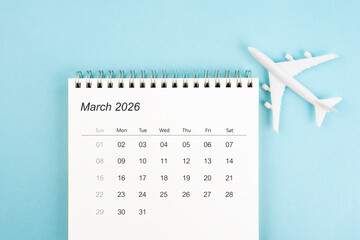 March 2026 calendar and airplane toy on blue color background, Travel plan concepts.