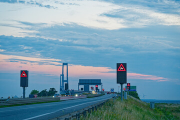The Oresund OEresund Bridge viewed from the east side near Korsor in Denmark at dusk with many signs