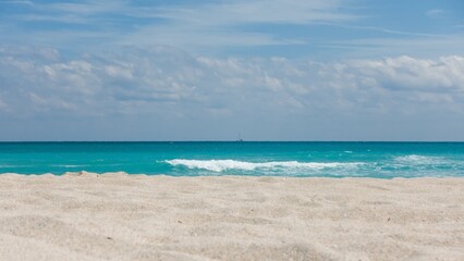 Florida beach with turquoise water and sailboat