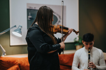Two young musicians practicing together in a cozy and inviting indoor space, focusing on their...