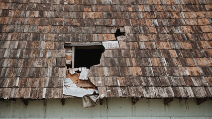 Antique crumbling roof in a townscape owing to structural failure
