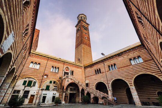 View of the brick tower rising above the courtyard, palazzo della ragione, Verona, Veneto, Italy.