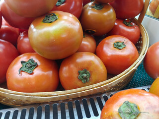 Pile of fresh tomatoes in a rattan wicker 