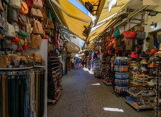 A narrow street with colorful stalls