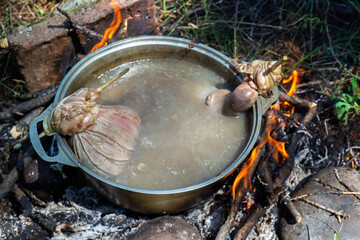 Boiled cooking of Blood sausage at cauldron on a camp fire. National Tuvan and Buryat cuisine....