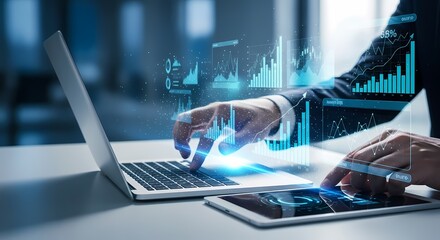 Businessperson using laptop and tablet with data charts