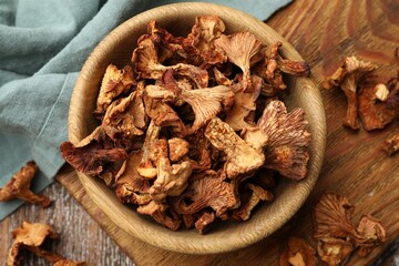 Dried chanterelle mushrooms on wooden table, flat lay