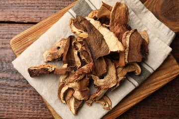 Fototapeta premium Dried chanterelle mushrooms on wooden table, top view