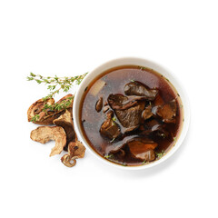 Tasty soup in bowl, thyme and dry chanterelle mushrooms isolated on white, top view