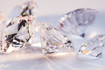 Many shiny diamonds on light background, closeup